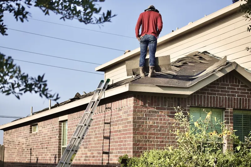 Professional roofer working on a residential roof in Morganton